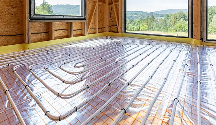 Radiant floor heating system being installed in a residential property for energy-efficient home heating.